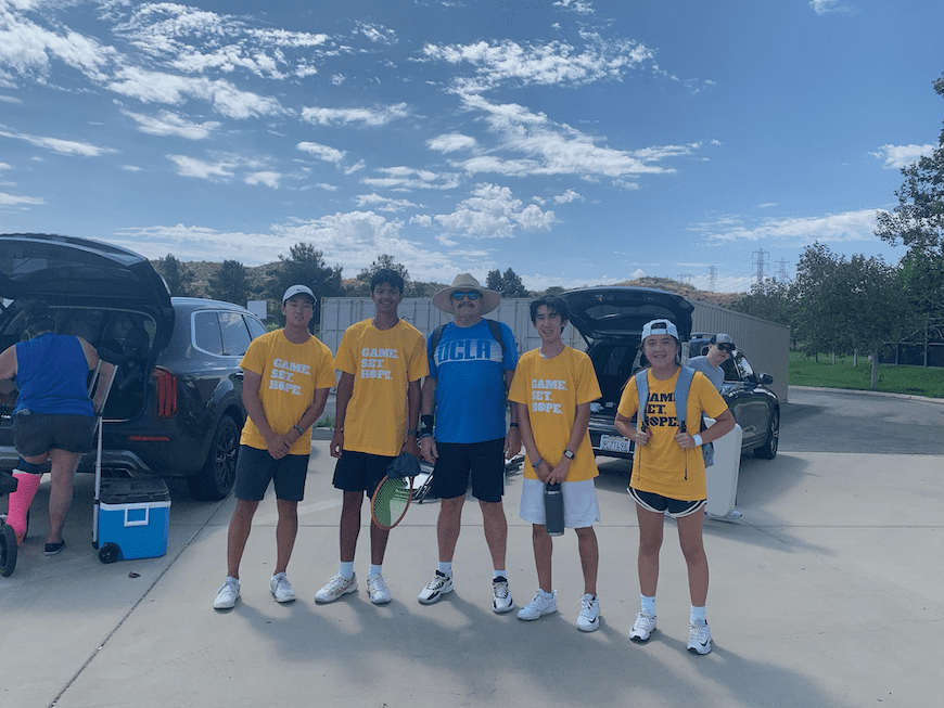 Park (second from the right), a coach, and his team get ready for their annual charity tennis tournament.